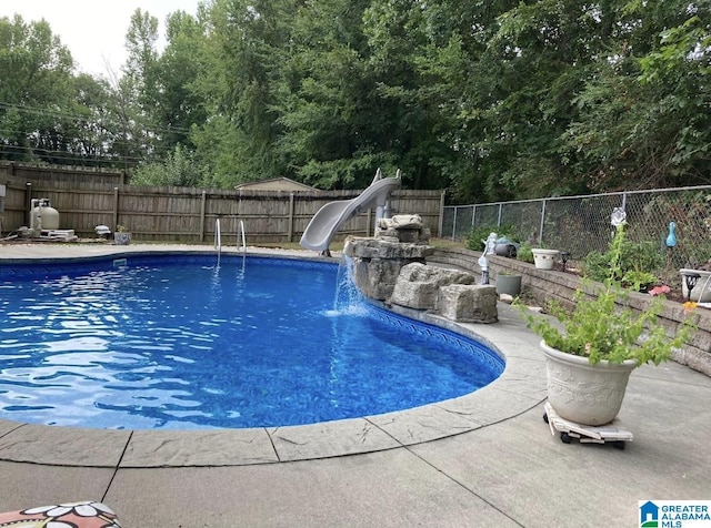 view of pool featuring pool water feature and a water slide