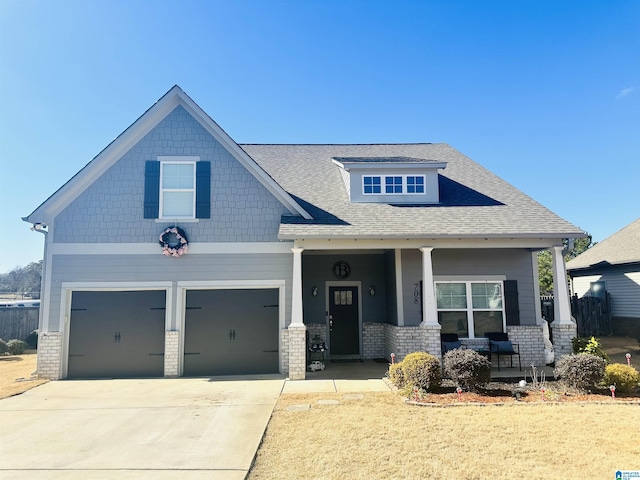 craftsman inspired home featuring a porch and a garage