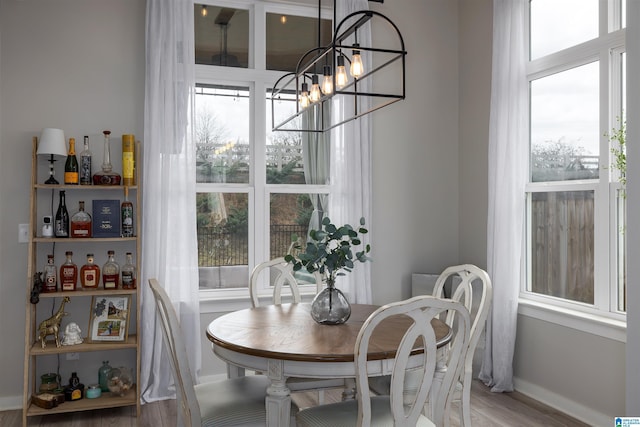 dining space featuring an inviting chandelier and wood-type flooring