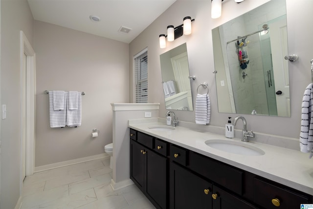 bathroom featuring vanity, toilet, and walk in shower