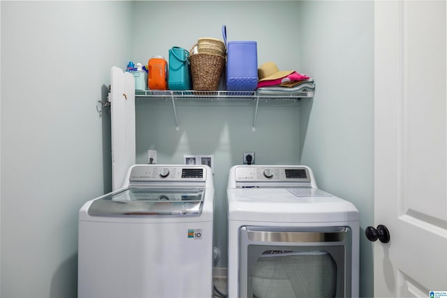 clothes washing area with washing machine and dryer