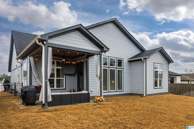 back of property featuring a yard and an outdoor hangout area