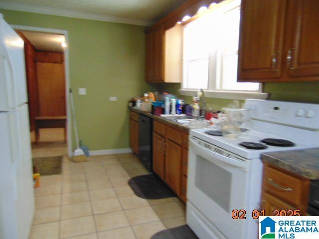 kitchen featuring ornamental molding, light tile patterned floors, and white appliances