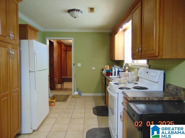 kitchen with white appliances, ornamental molding, and light tile patterned floors