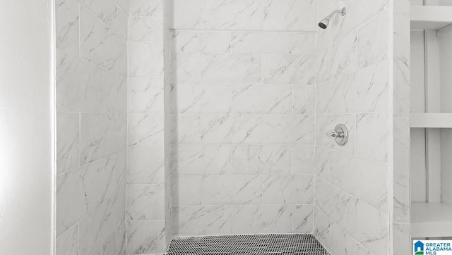 bathroom with a tile shower