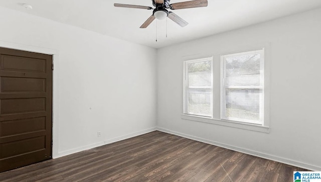 spare room with dark wood-type flooring and ceiling fan