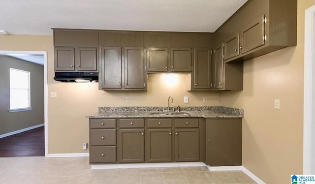 kitchen with sink and light stone countertops