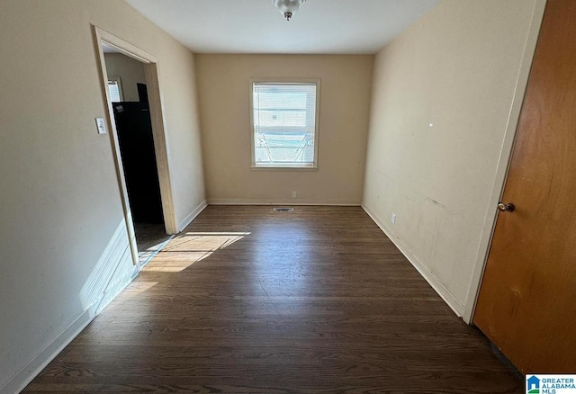 unfurnished room featuring dark hardwood / wood-style flooring