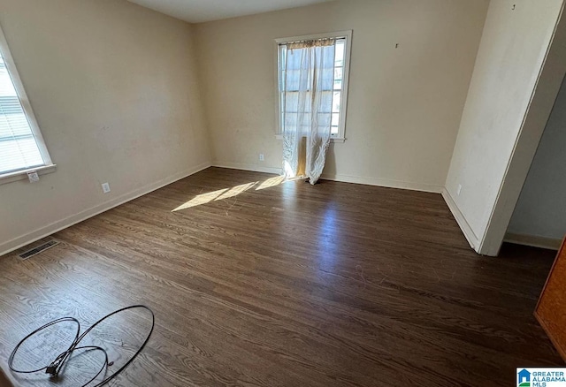 unfurnished room with dark hardwood / wood-style floors