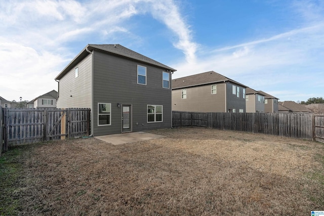 back of property featuring a yard and a patio area