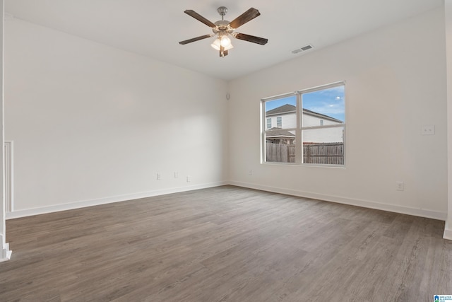 empty room featuring hardwood / wood-style floors and ceiling fan