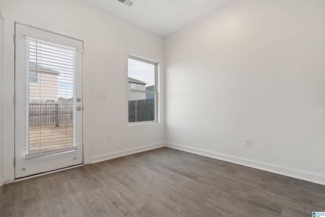 spare room featuring wood-type flooring