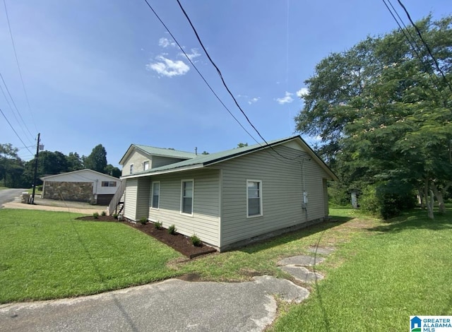 view of property exterior with a yard