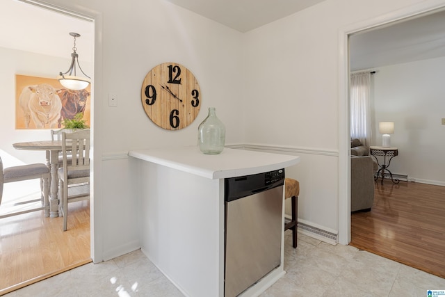 kitchen with pendant lighting, light hardwood / wood-style floors, and dishwasher