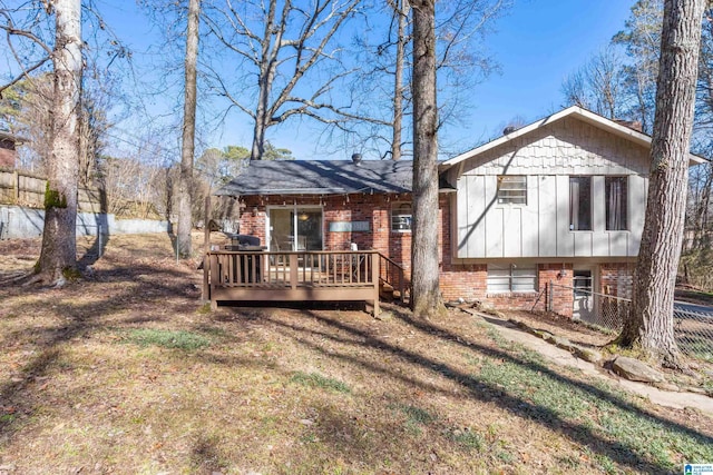 back of house with a wooden deck and a yard