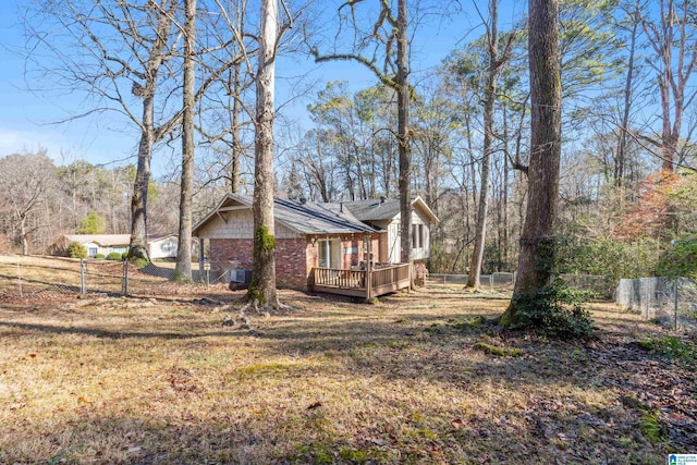 view of side of property with a yard and a deck