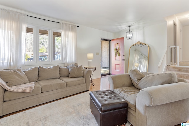 living room with an inviting chandelier and wood-type flooring