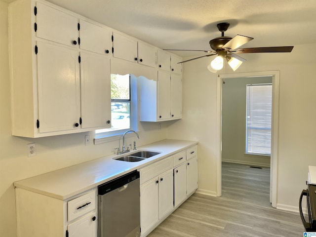 kitchen with white cabinetry, dishwasher, sink, ceiling fan, and light hardwood / wood-style flooring