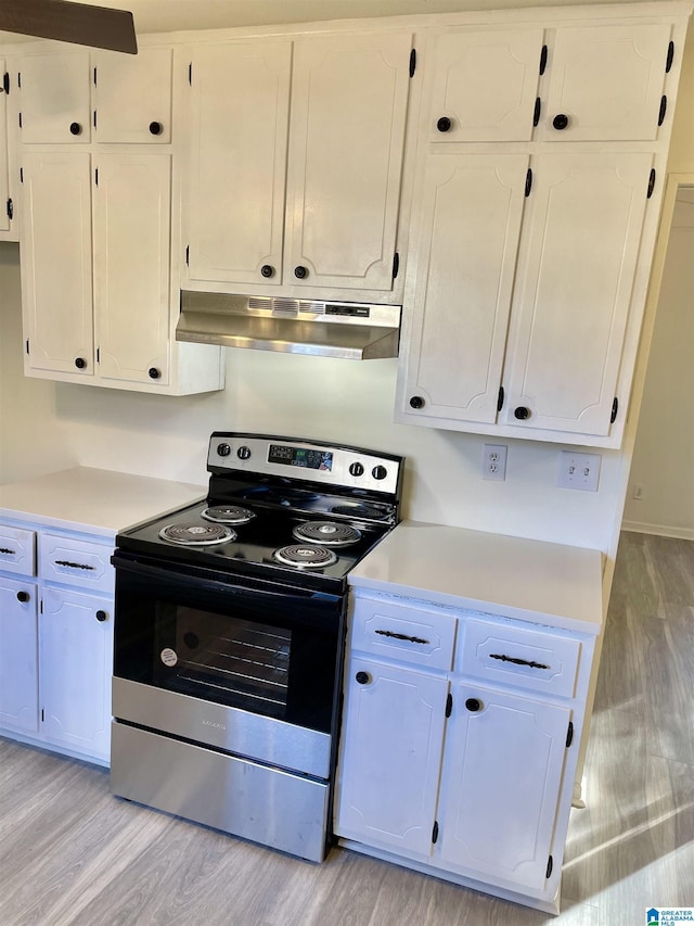 kitchen featuring white cabinetry, light hardwood / wood-style floors, and stainless steel range with electric stovetop