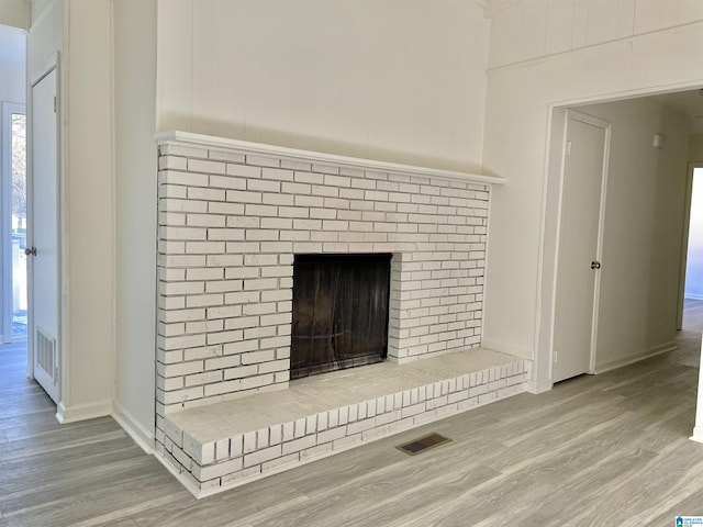 room details with a brick fireplace and hardwood / wood-style floors