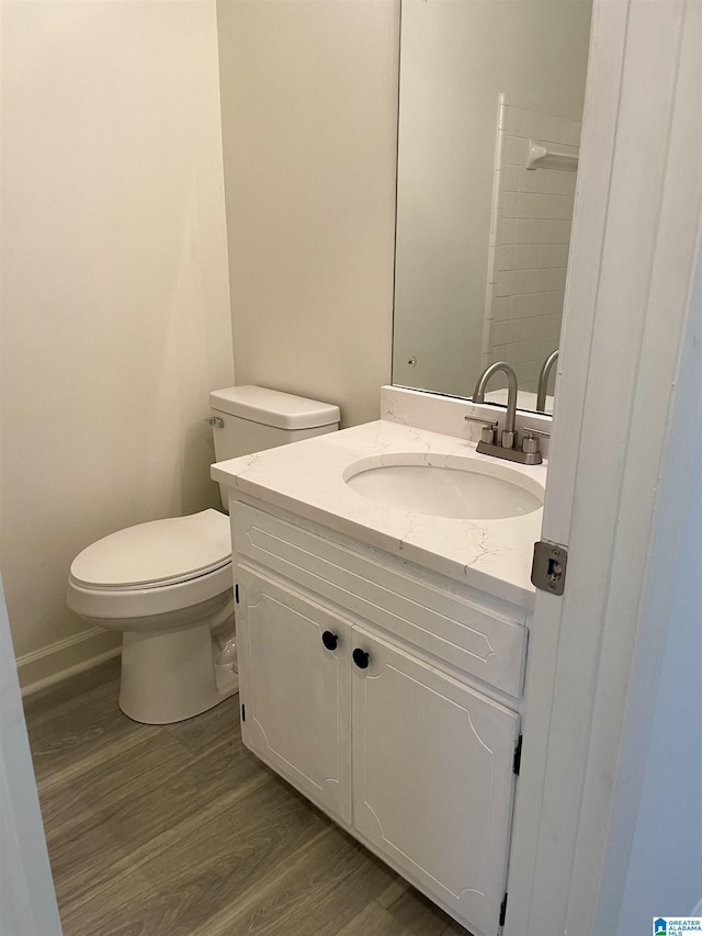 bathroom featuring hardwood / wood-style flooring, vanity, and toilet