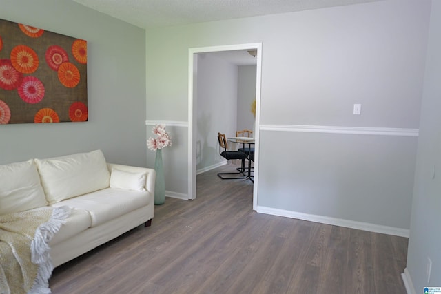 living room with dark hardwood / wood-style flooring