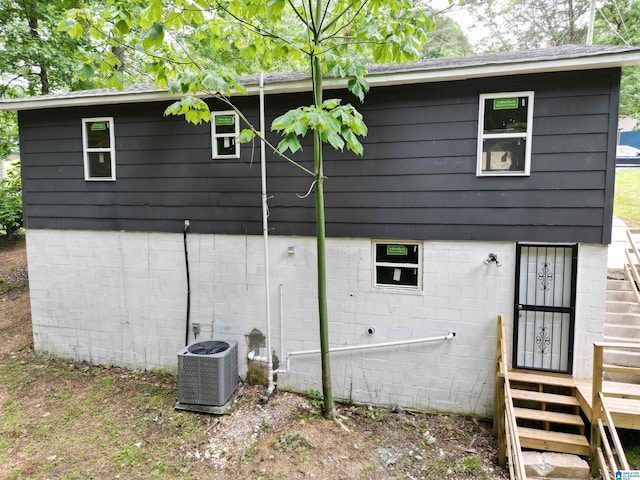 view of side of home featuring central air condition unit