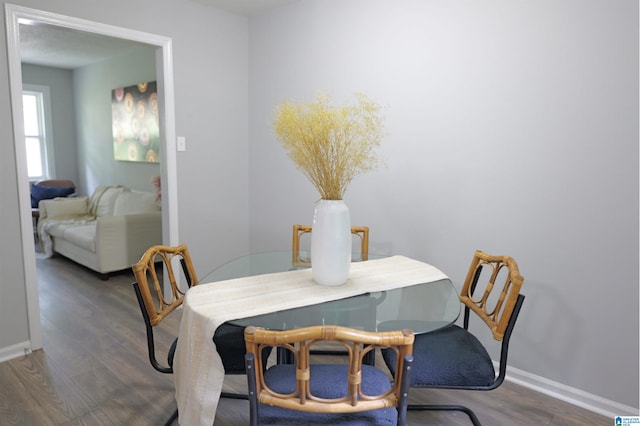 dining space featuring dark hardwood / wood-style flooring