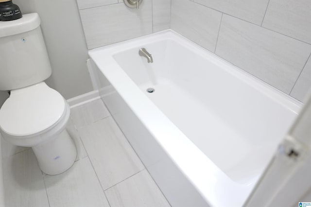 bathroom with toilet and a bathing tub