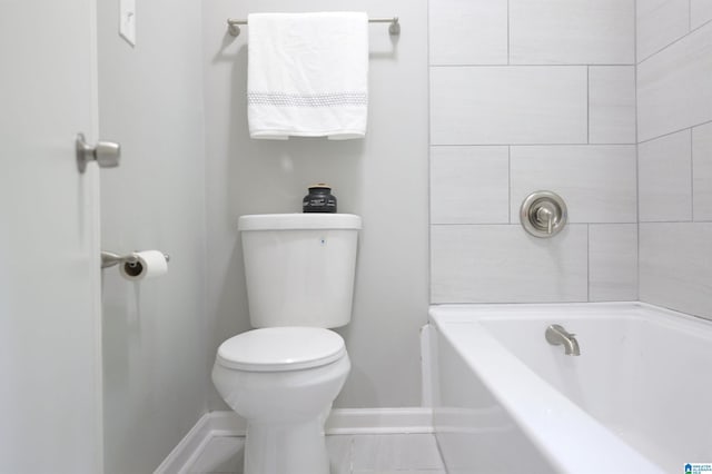 bathroom with a tub and toilet