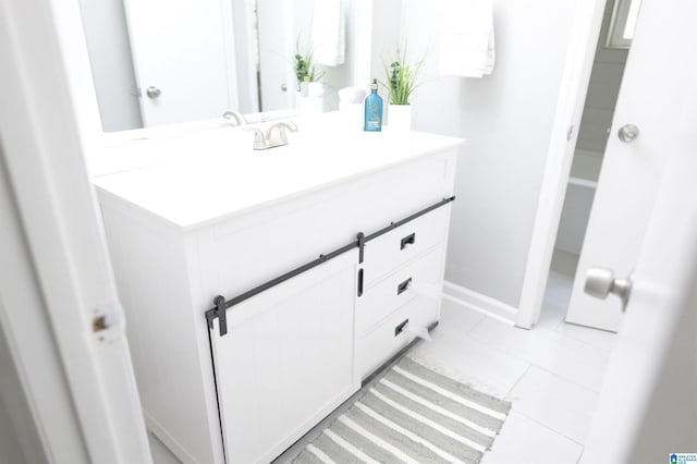 bathroom with tile patterned floors and vanity