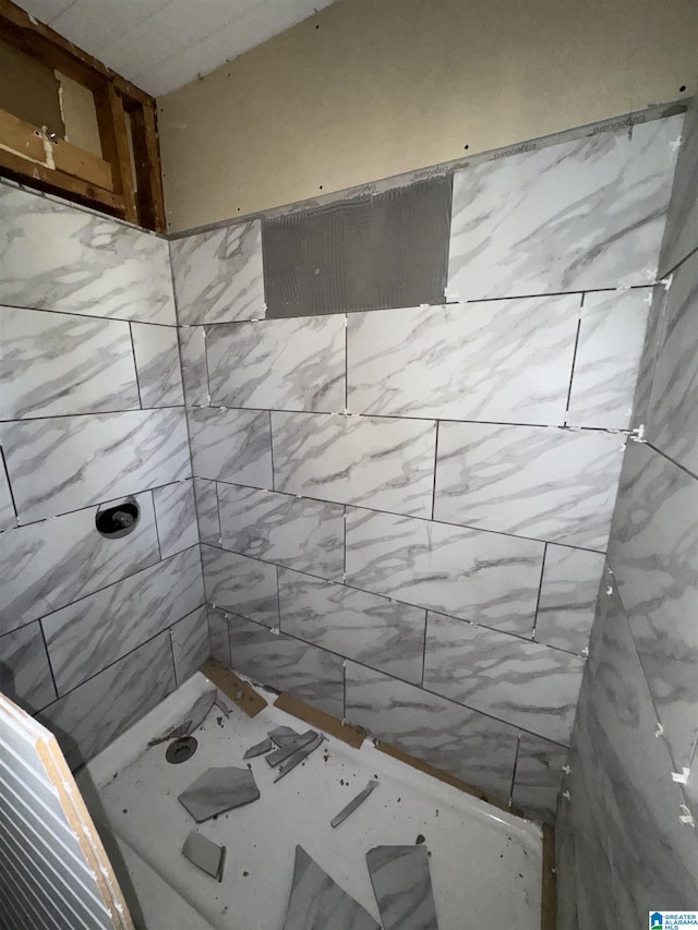 bathroom with a tile shower