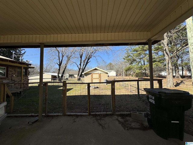 view of patio featuring a storage shed