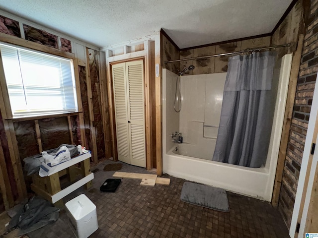 bathroom with shower / bath combo and a textured ceiling