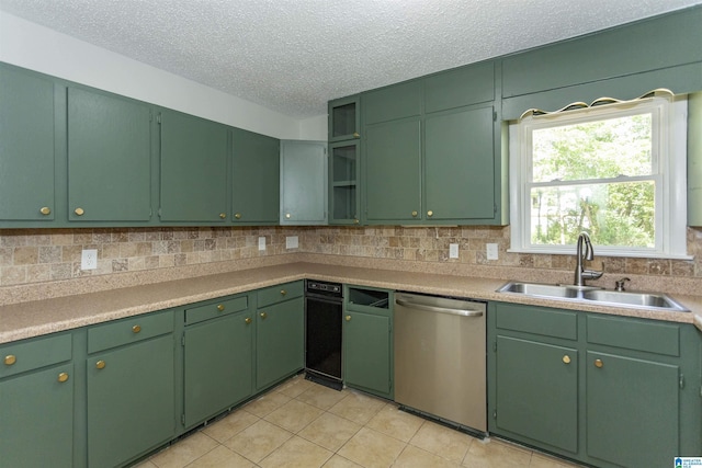 kitchen featuring tasteful backsplash, sink, stainless steel dishwasher, and green cabinets