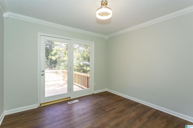 empty room with dark hardwood / wood-style flooring, ornamental molding, and a textured ceiling