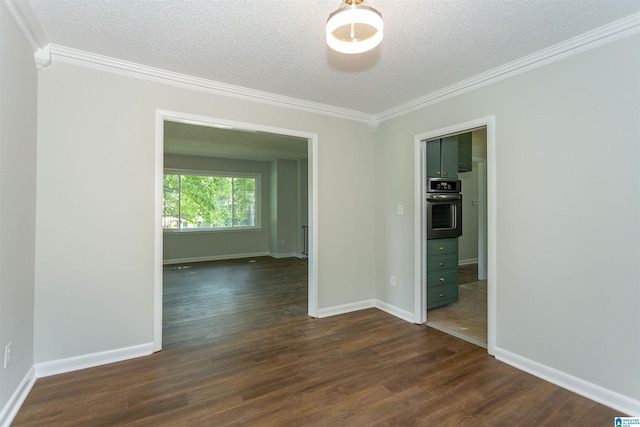 spare room featuring crown molding, dark hardwood / wood-style floors, and a textured ceiling