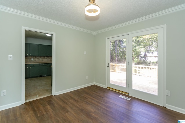 empty room featuring dark hardwood / wood-style flooring, crown molding, and a textured ceiling