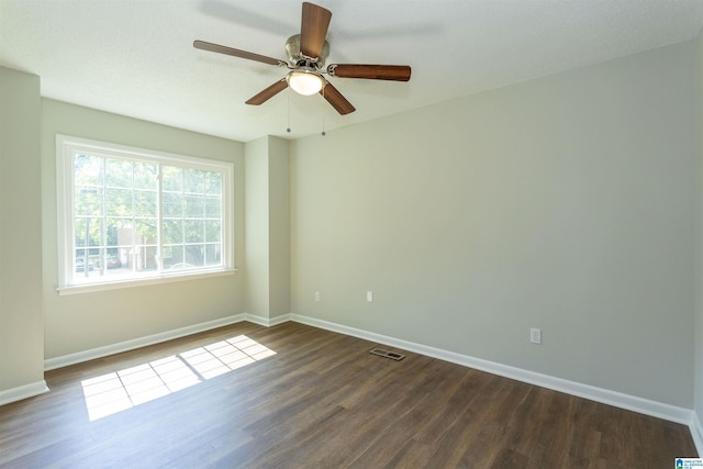 empty room featuring ceiling fan and dark hardwood / wood-style flooring