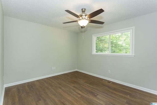 unfurnished room featuring ceiling fan, a textured ceiling, and dark hardwood / wood-style flooring