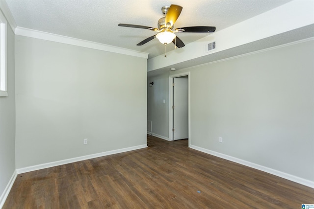 empty room with ceiling fan, crown molding, dark wood-type flooring, and a textured ceiling