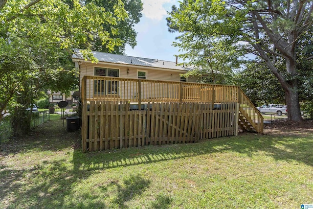 view of yard with central AC unit and a deck