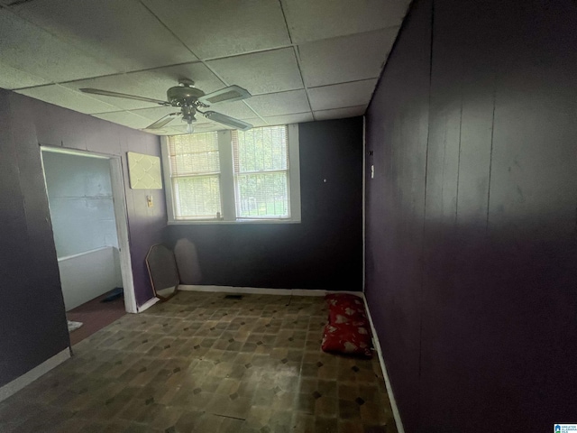 interior space featuring hardwood / wood-style flooring, a paneled ceiling, and ceiling fan