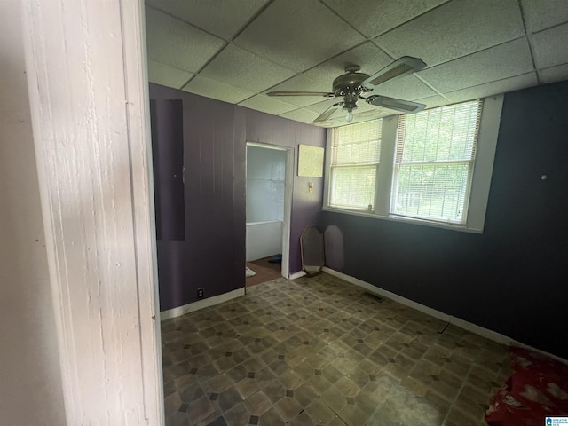 spare room featuring a drop ceiling and ceiling fan