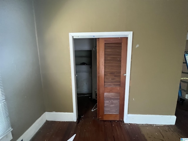 unfurnished bedroom with dark wood-type flooring