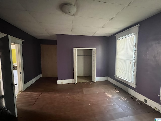 unfurnished bedroom featuring a drop ceiling