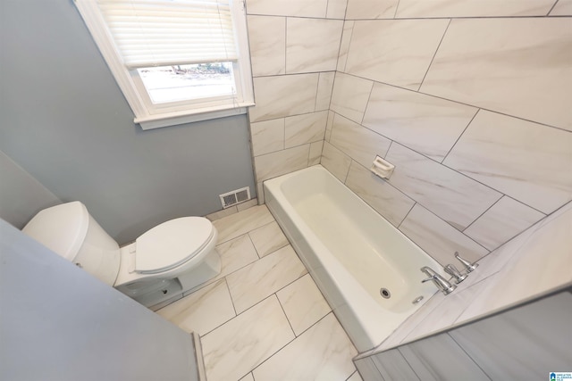 bathroom featuring toilet and a tub