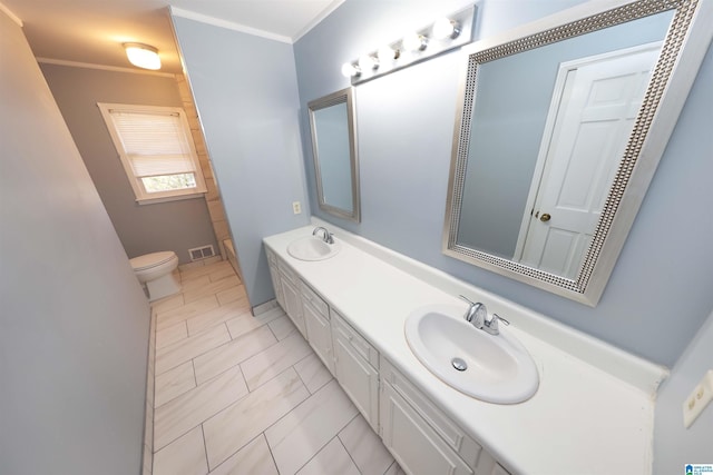 bathroom featuring crown molding, vanity, and toilet