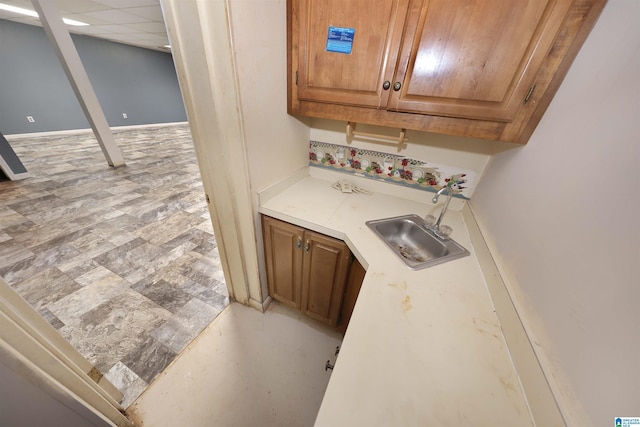 kitchen with a drop ceiling and sink