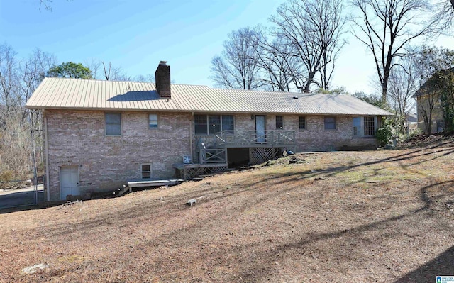 back of property with a wooden deck